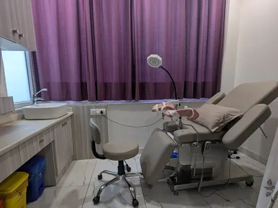 The examination room at Ekam, a curtained window and an examination bed.