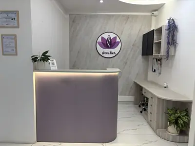The reception desk at Ekam, with the clinic's lotus mark on the wall.